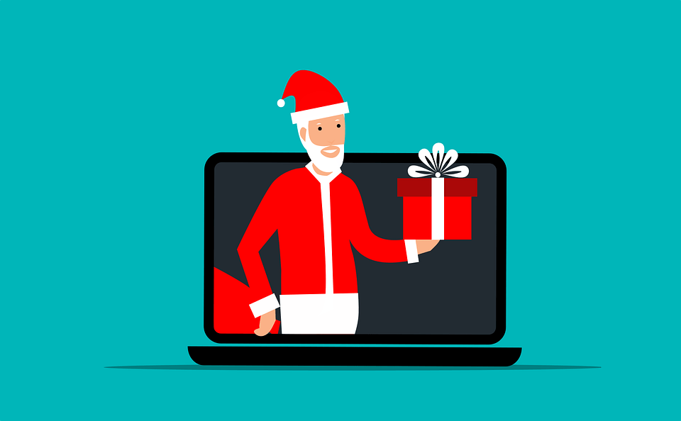 An image of Santa holding a gift inside the laptop screen
