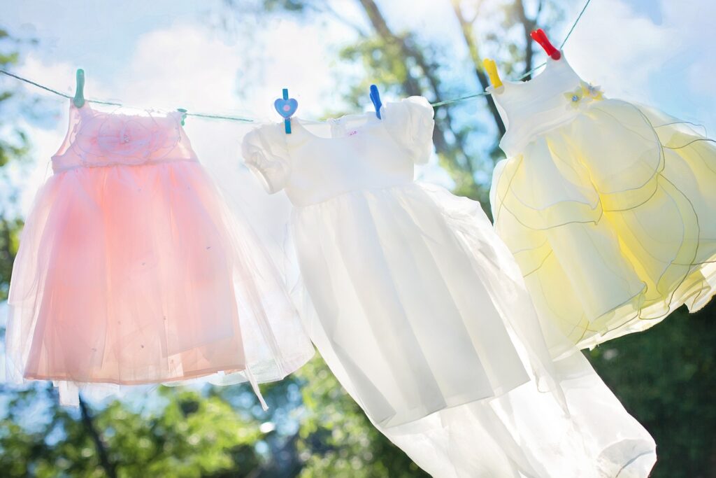 an image of hanging dresses on a clothesline for drying