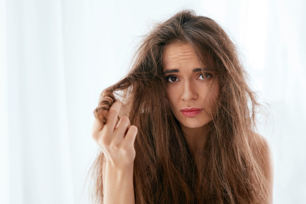 An image of A woman with dry and damaged hair