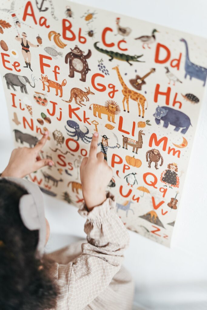 A child pointing at letters

