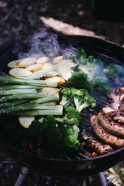 A grill with vegetables and meat
