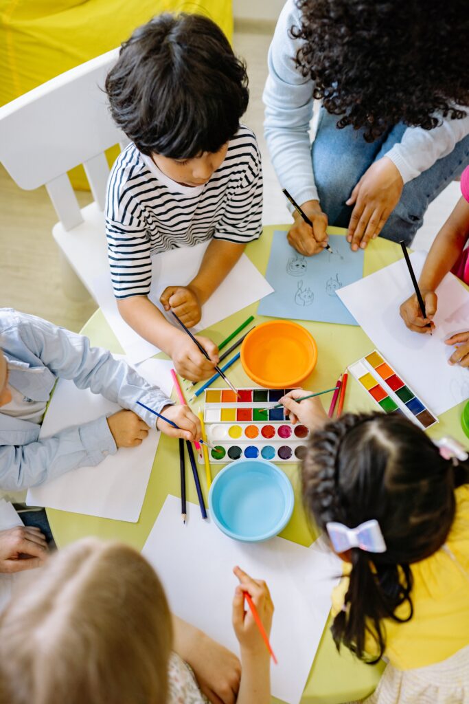 A group of children painting with watercolors image