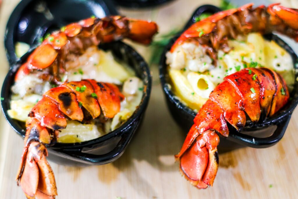  lobster dish with cheese placed in black bowls image