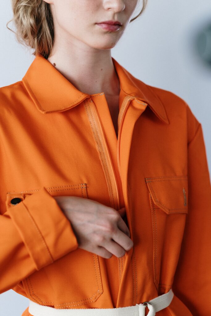 a woman in orange overall suit