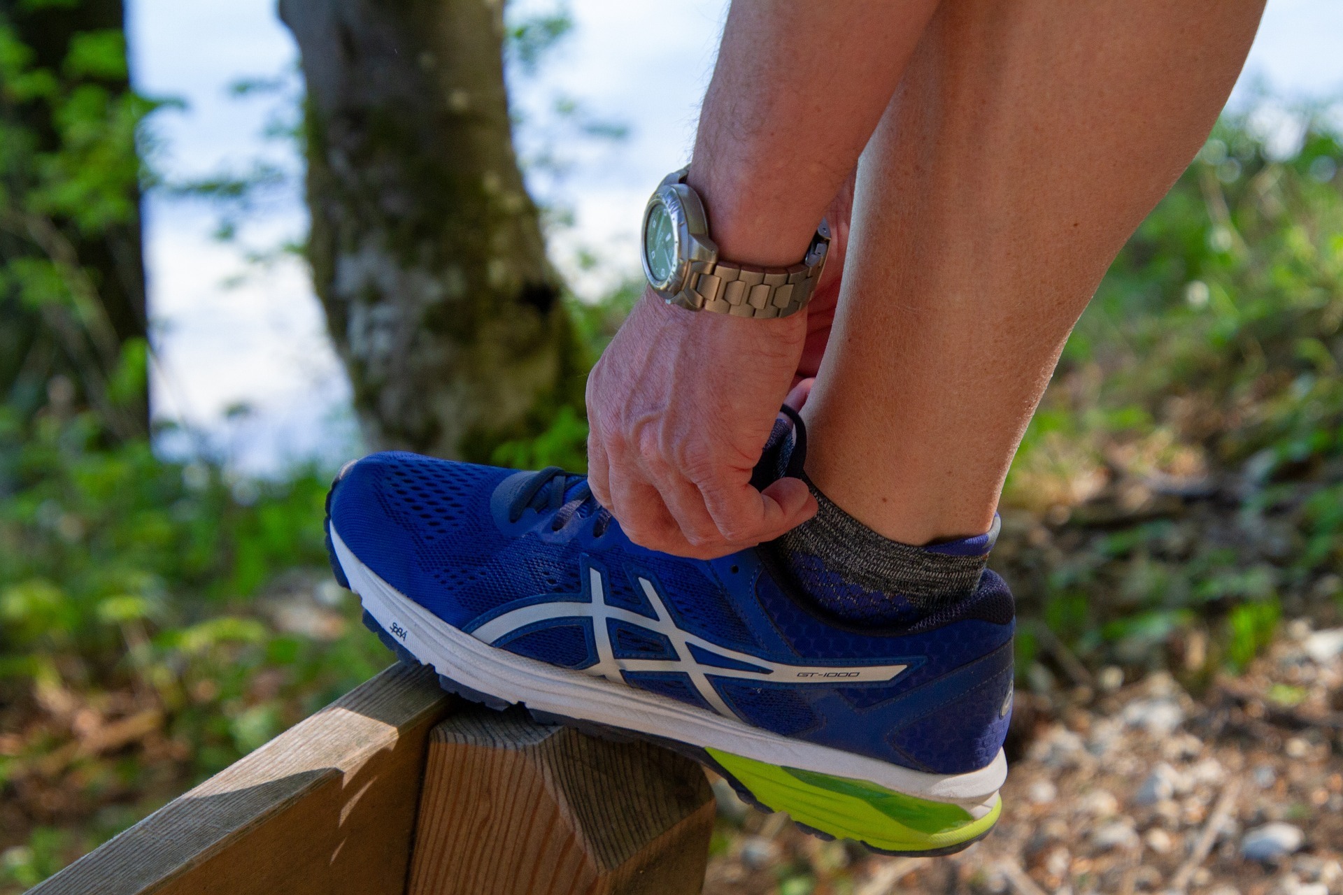 A person adjusting their running shoes