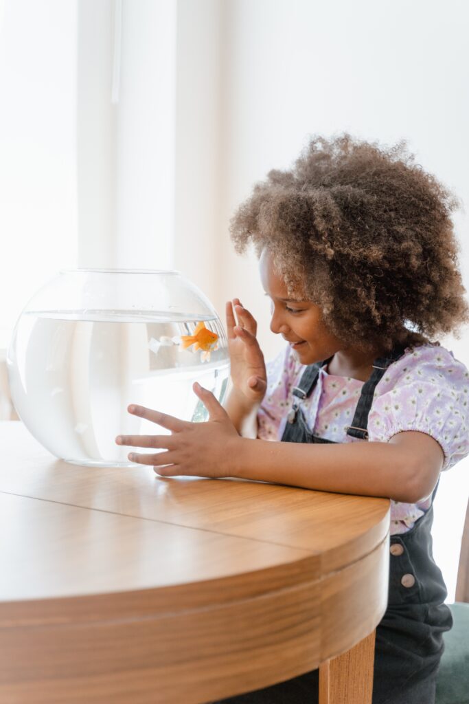  Girl playing with her pet fish