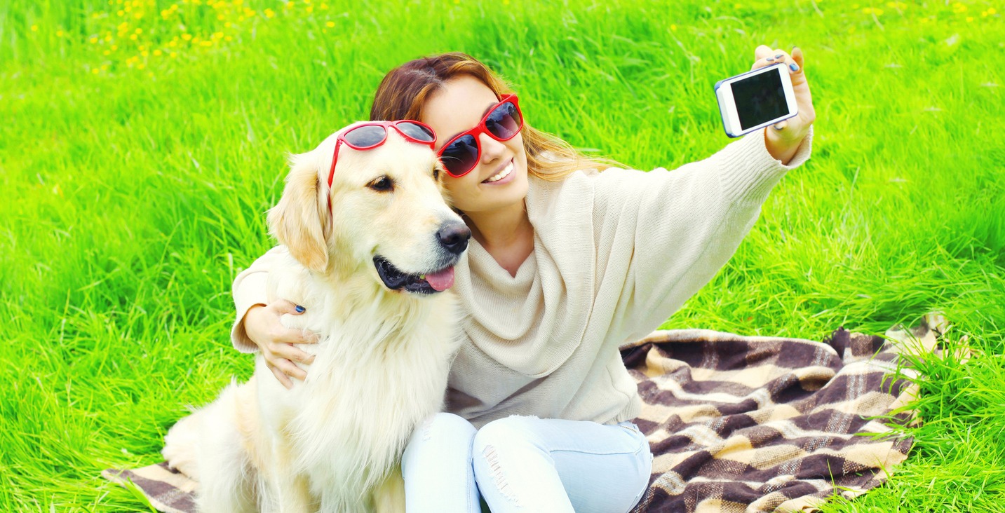 a woman takes a selfie with her dog