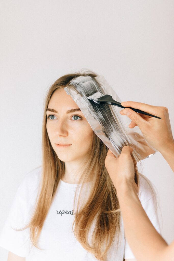 woman getting her hair dyed image