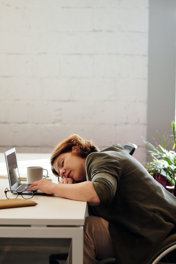 A woman sleeping on her desk image