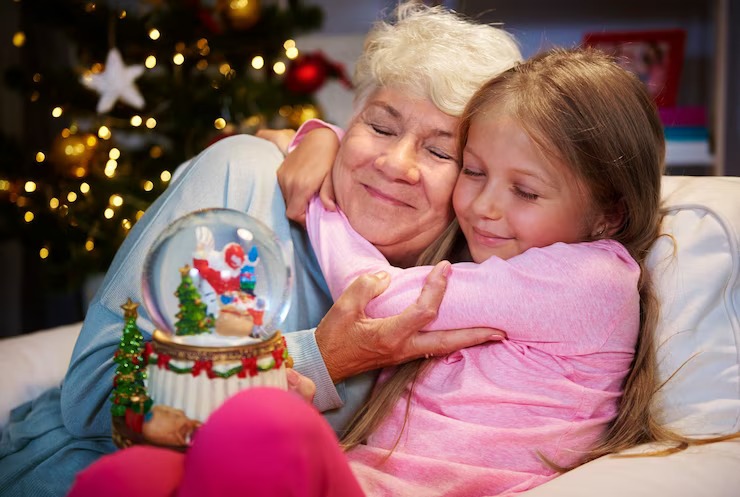 Grandma and girl hugging with a snow globe image