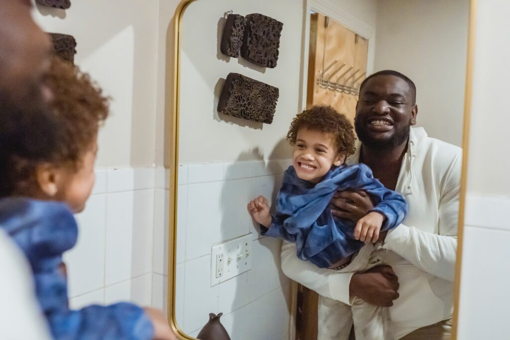  father and son in the bathroom image