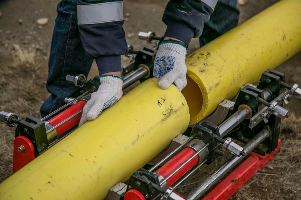 person-holding-yellow-pipes image