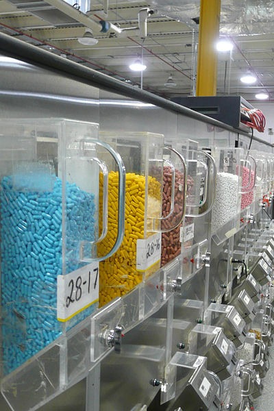 Canisters containing pharmaceuticals are loaded into an automatic dispensing machine at a mail-order pharmacy