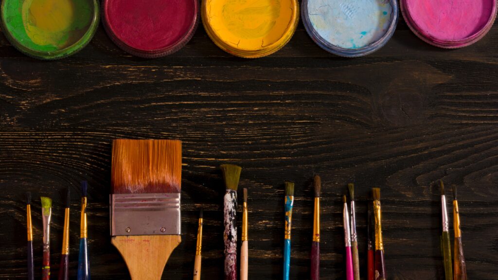  different sizes of paintbrushes of paint colors image