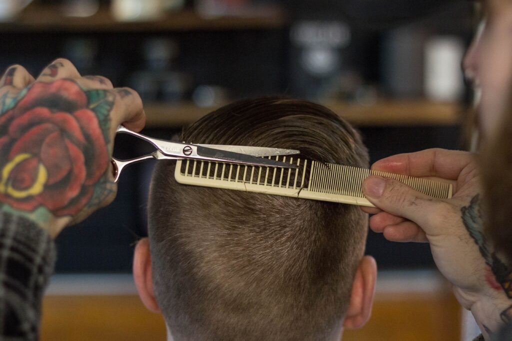 A closeup image of a Man getting a haircut