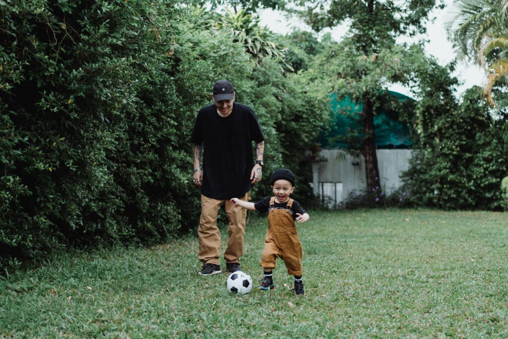Father and son playing a ball image