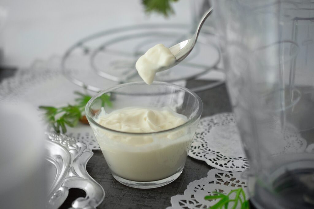  a bowl of mayonnaise with a spoon image