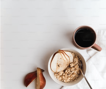 a bowl of oatmeal with apples and a cup of coffee