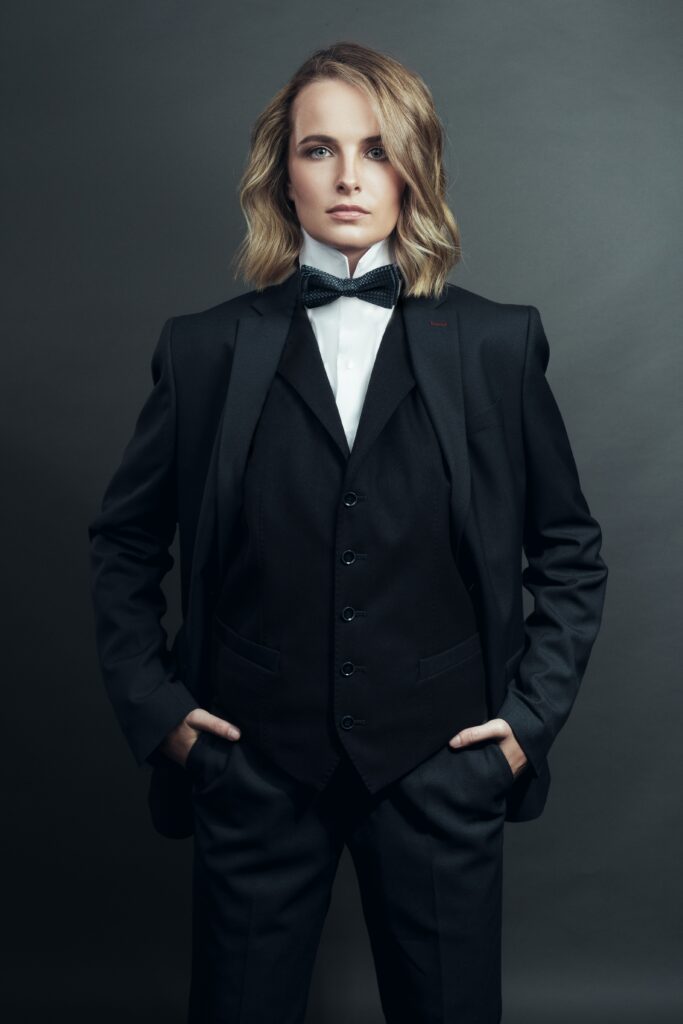 blond woman with long hair wearing tuxedo image