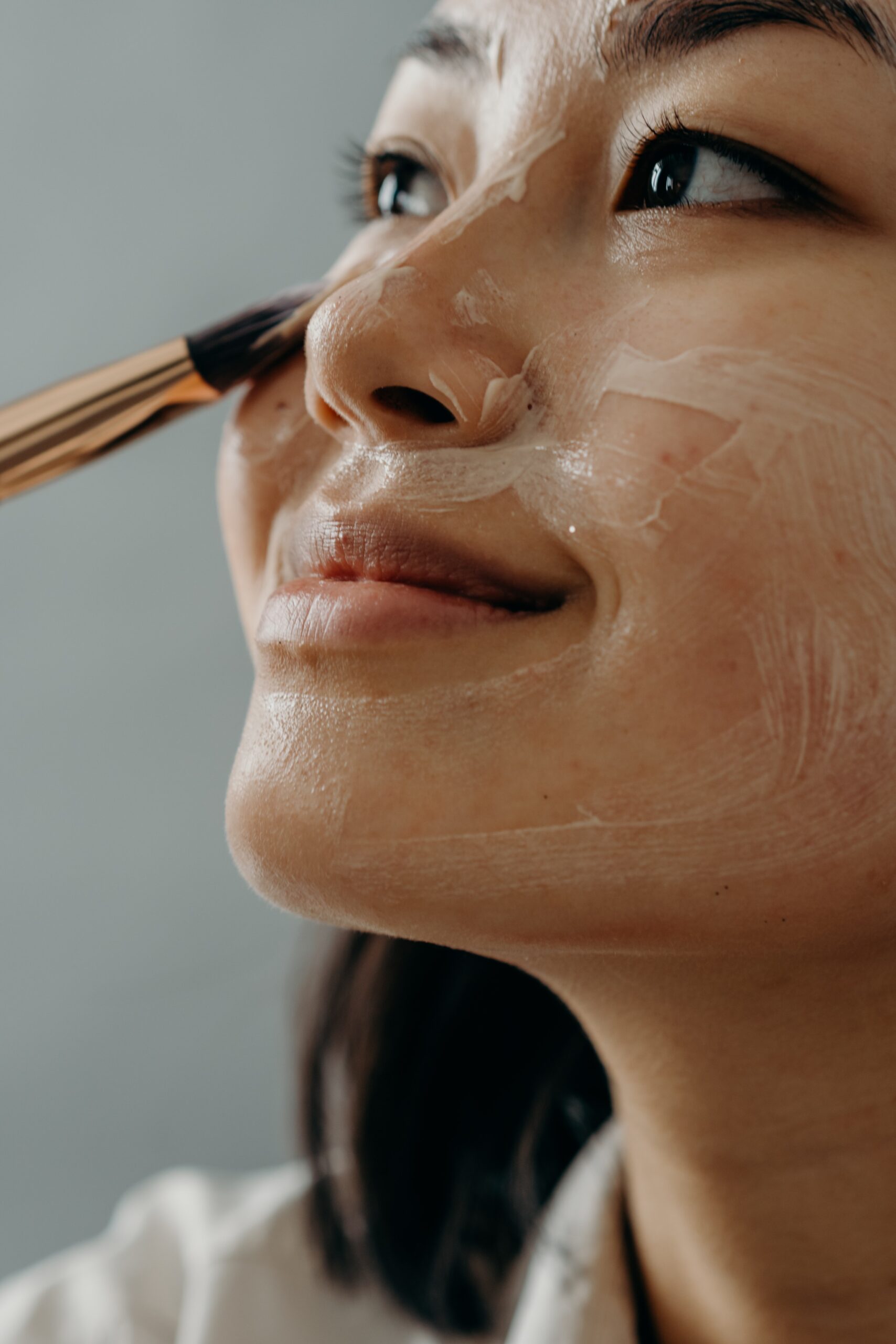 girl applying cream on her face