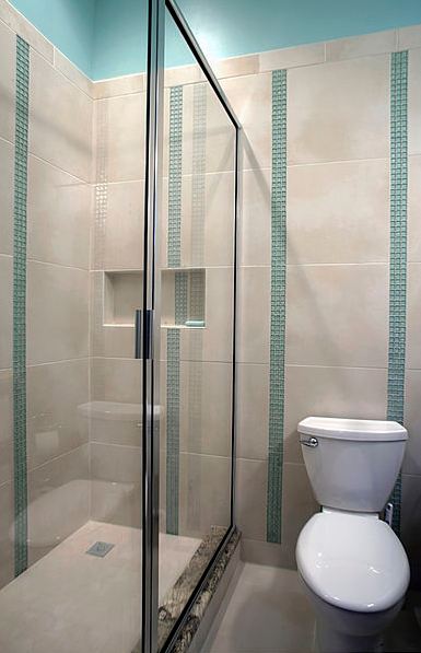 A bathroom with glass shower door