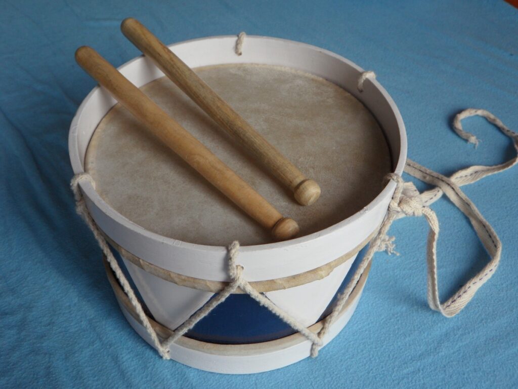 A child’s drum and drumsticks image