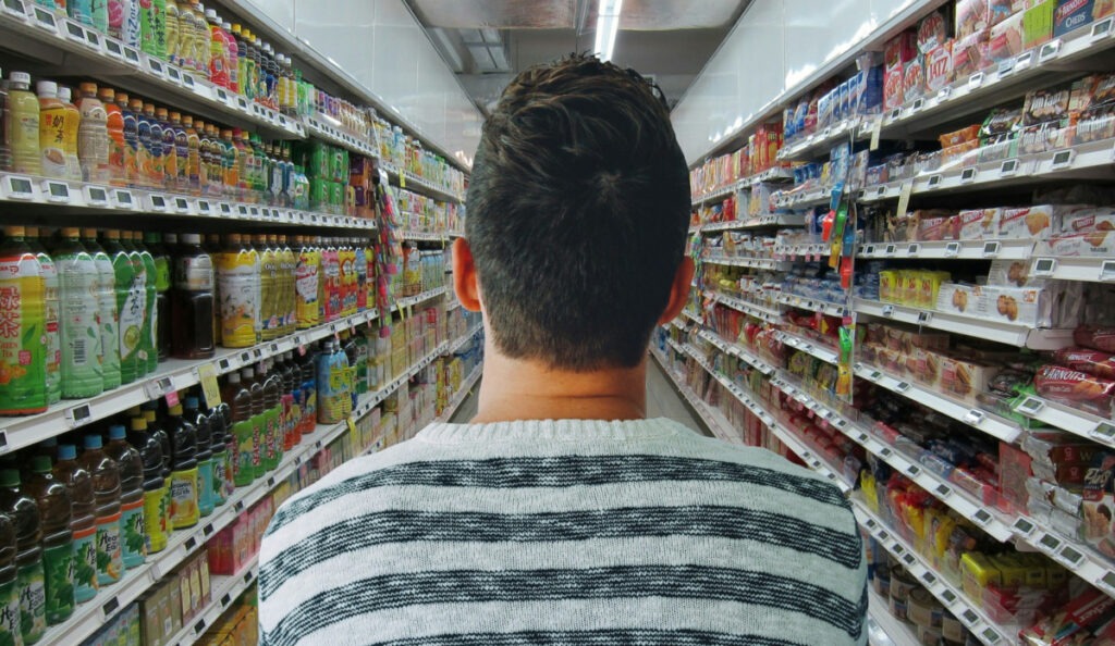 A man walking in a supermarket image