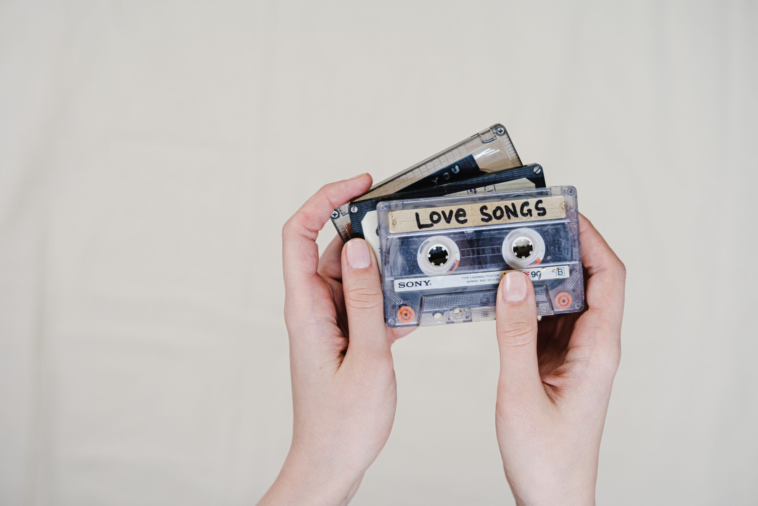 A person holding cassette tapes image