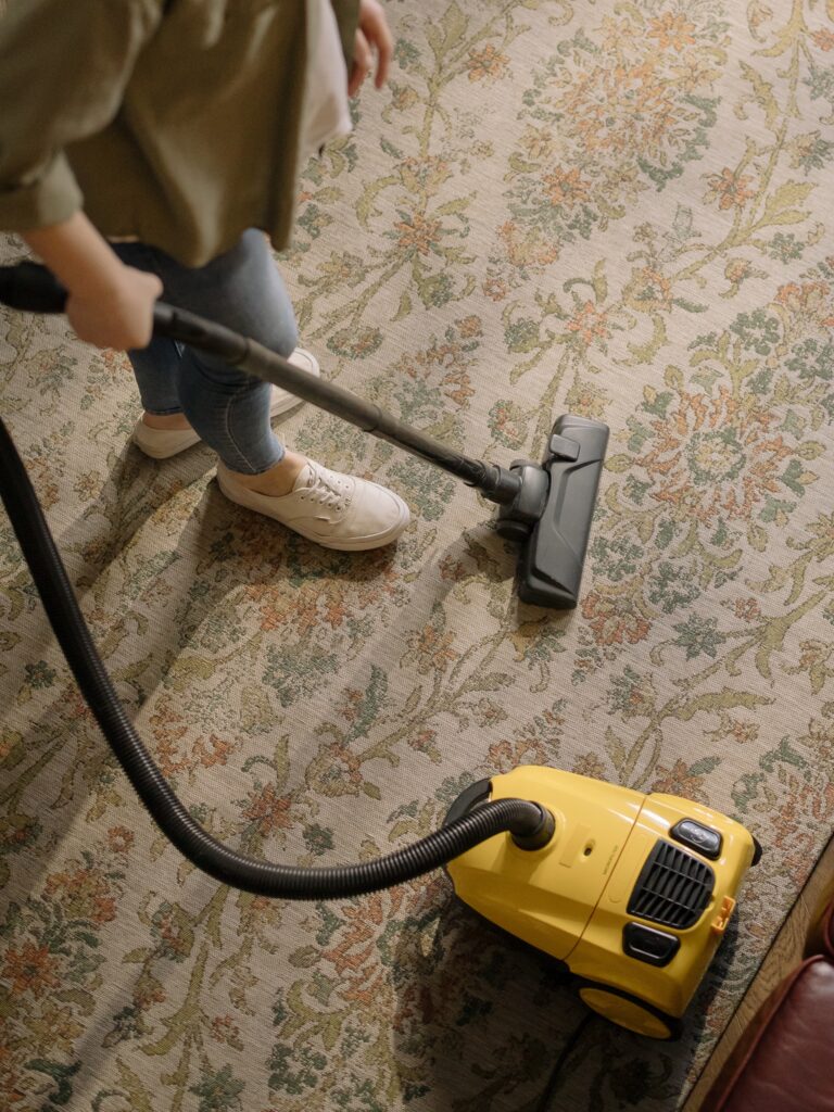 A woman vacuuming her carpet image
