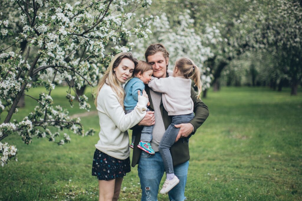 Happy family hugging outdoors image