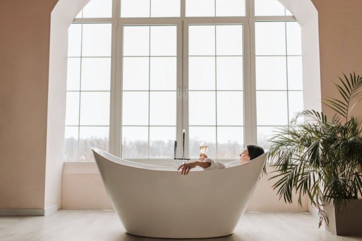 Woman lying on a bathtub