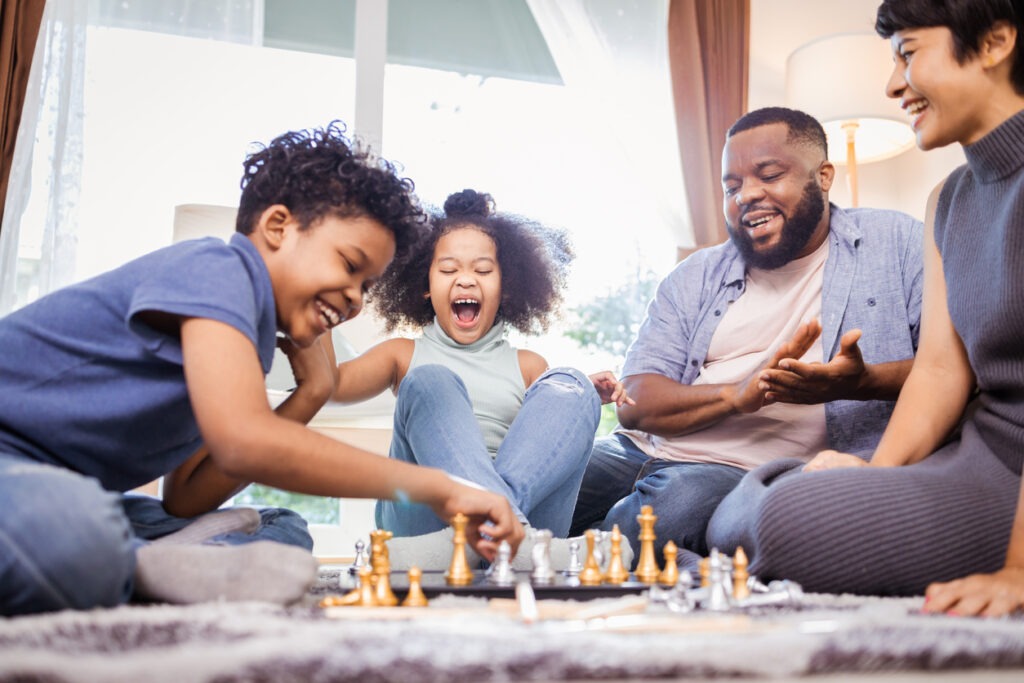 Happy family playing Chess