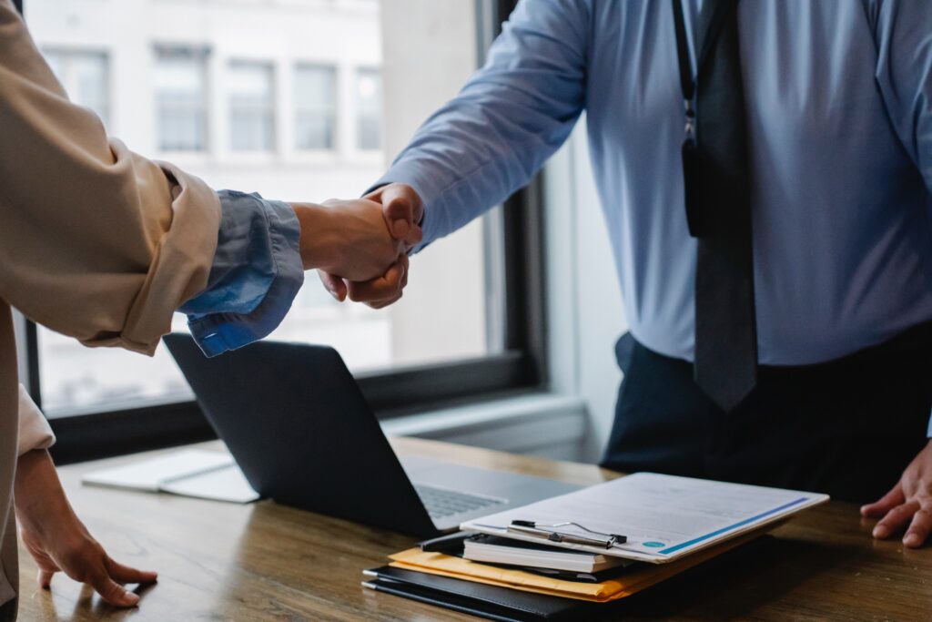 colleague shaking hands in office image