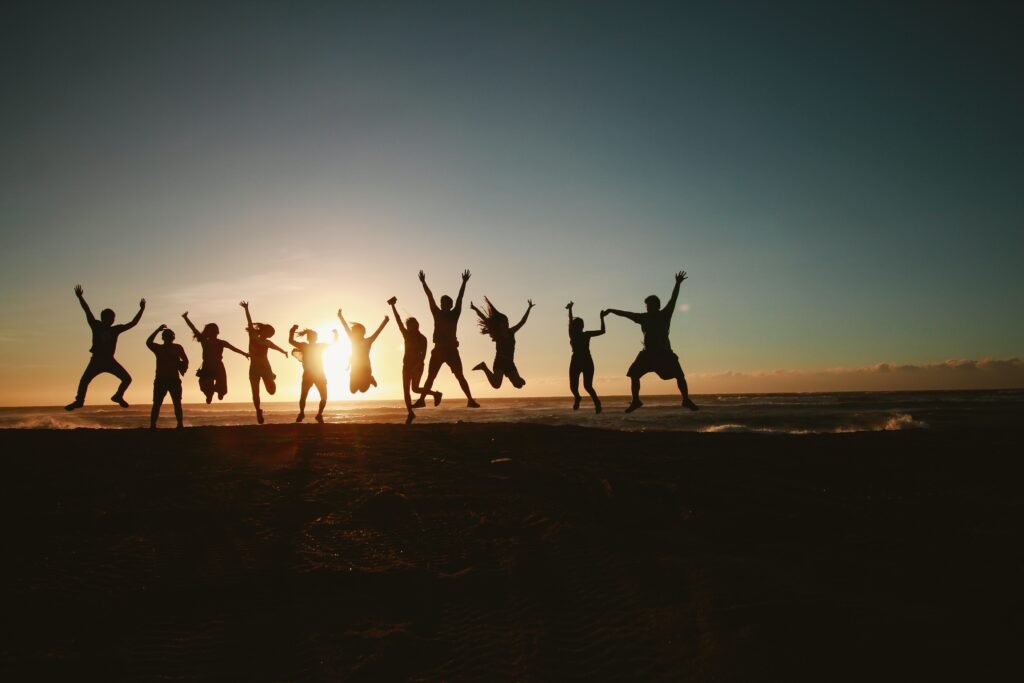 group of people jumping during golden time image