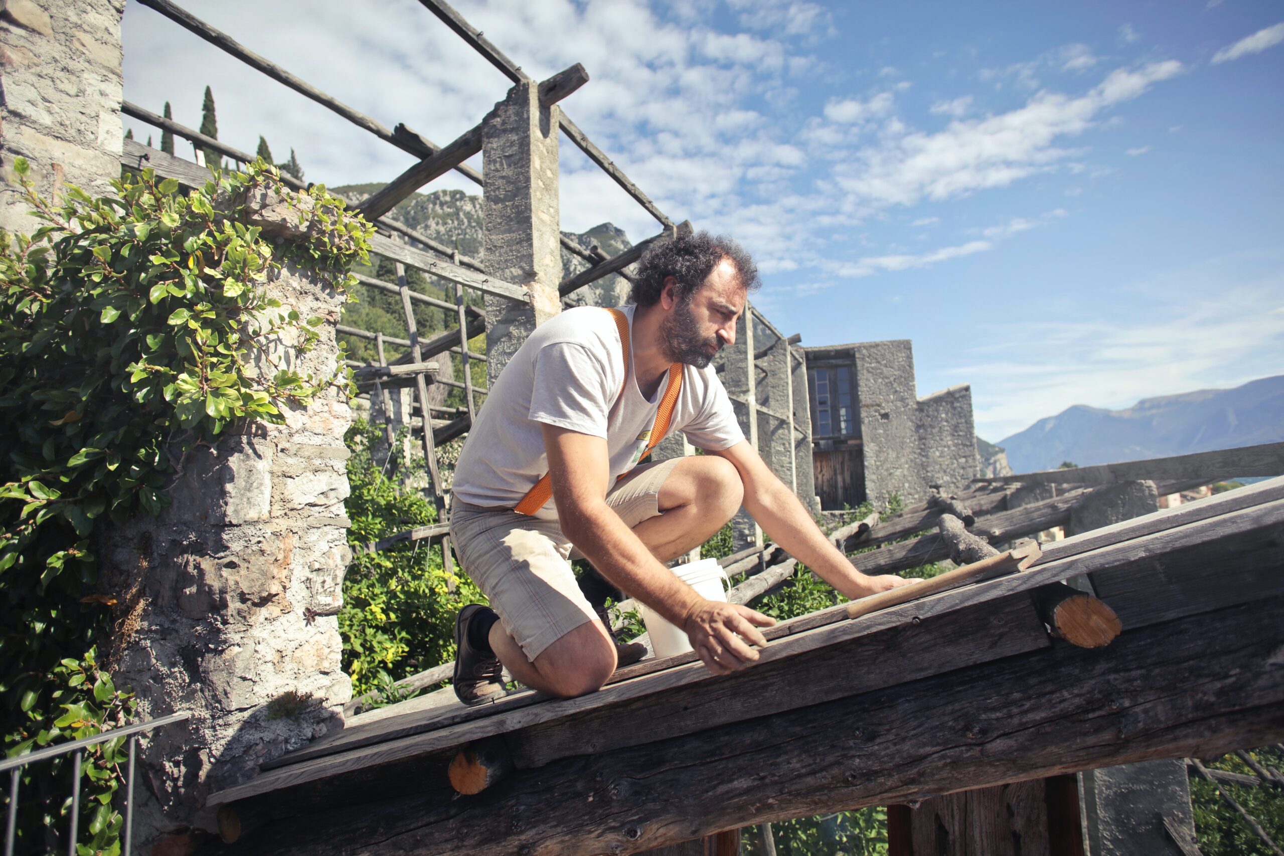 A man repairing a roof of a house