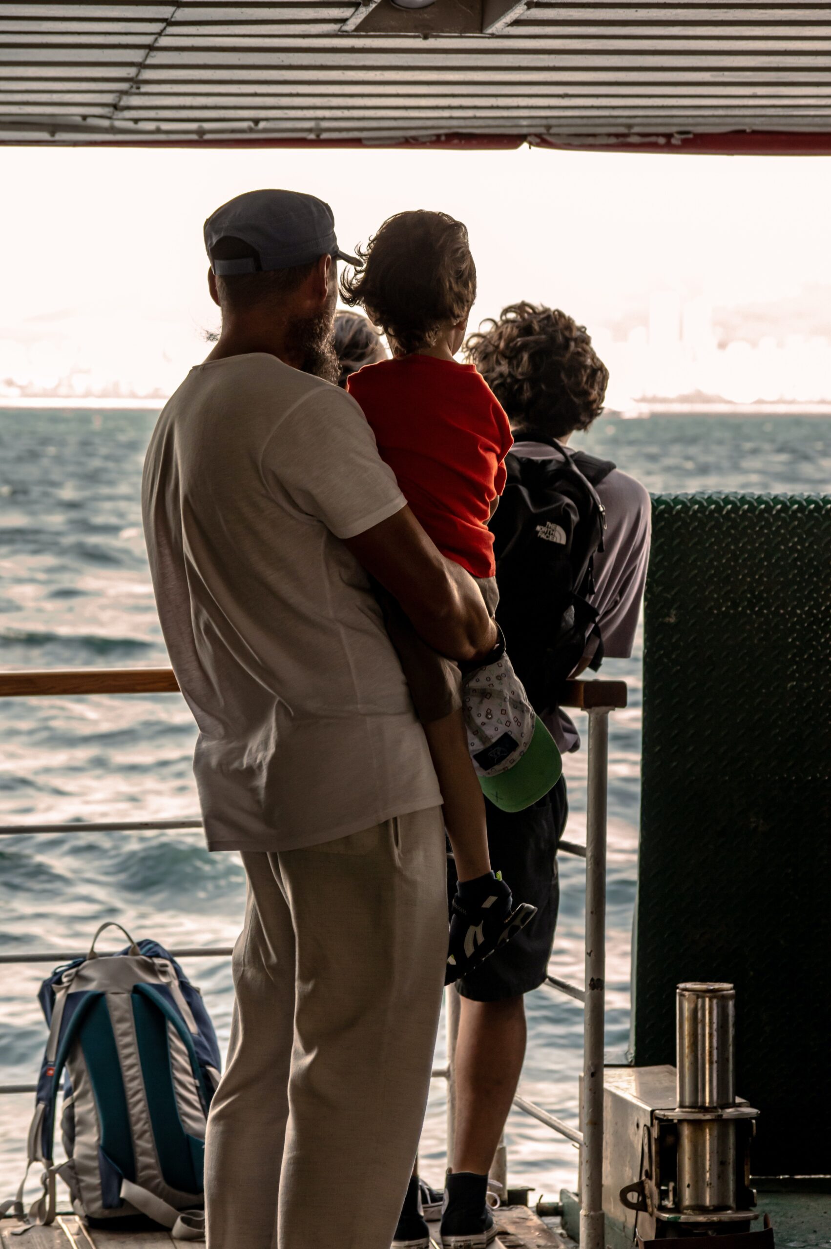A man standing with his children on a ship image