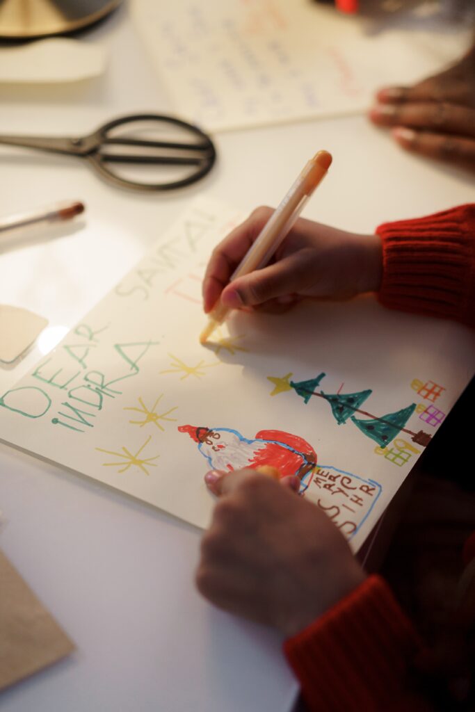 A person in red sweater making a christmas letter image