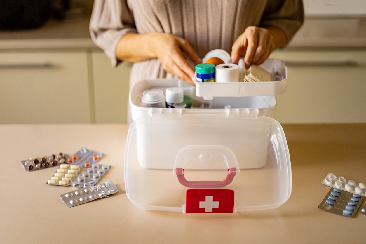A woman packing a first-aid kit