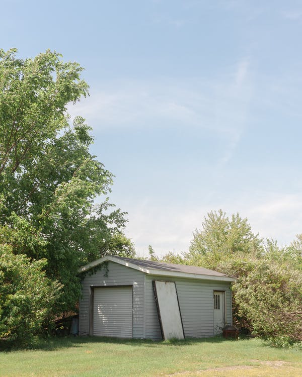 a wooden shed in the yard