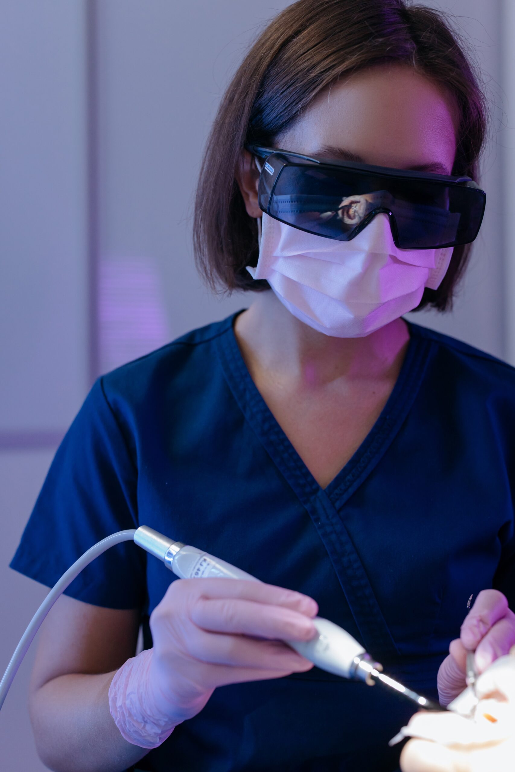 dentist wearing facemask and eye protection image