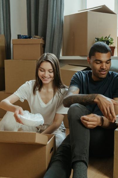 man and woman packing items in boxes