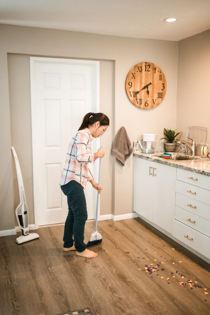 woman sweeping the floor image