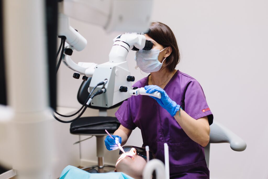 A dentist using dental equipment image
