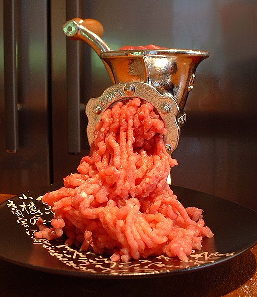 A meat grinder in operation image