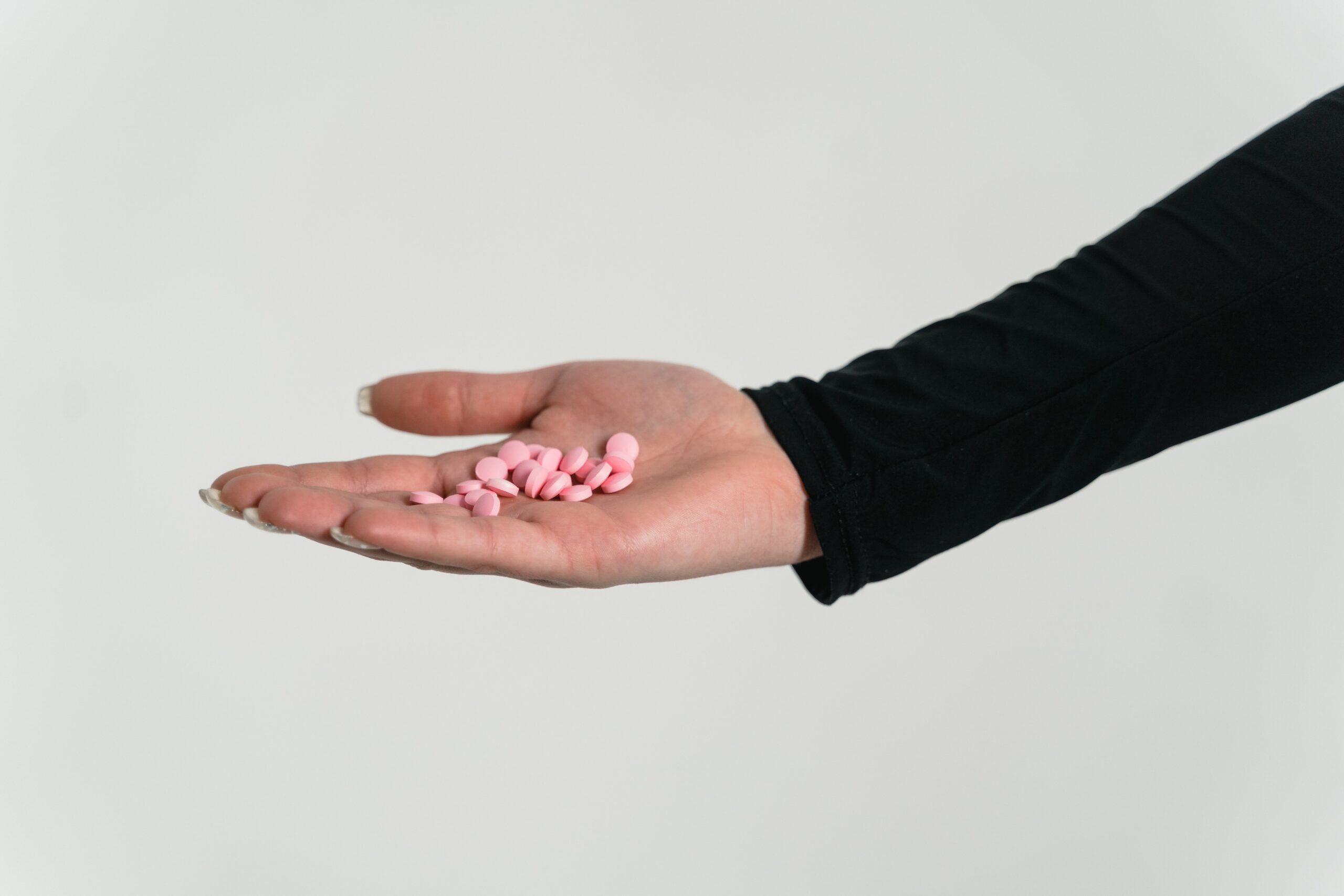 A person with a handful of pills