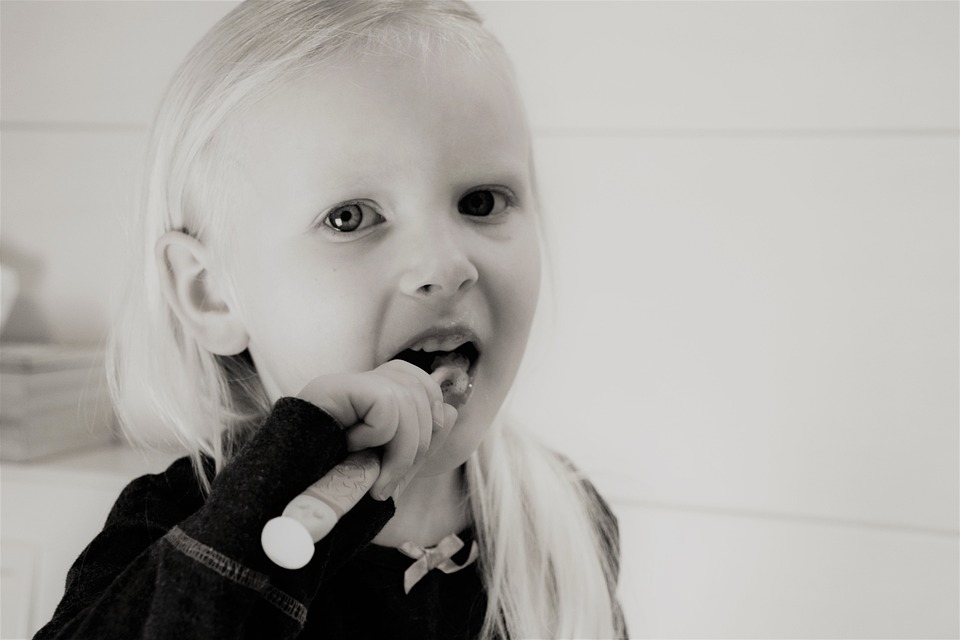 girl brushing teeth image