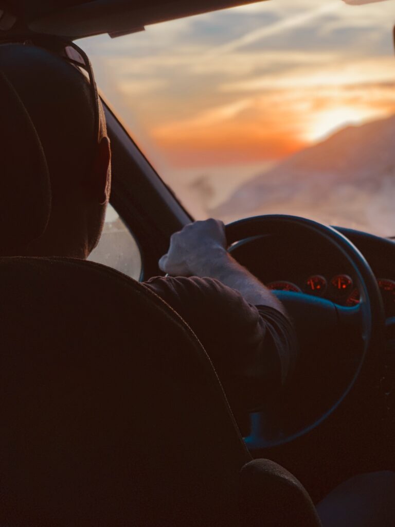 A person driving a car on a mountain image