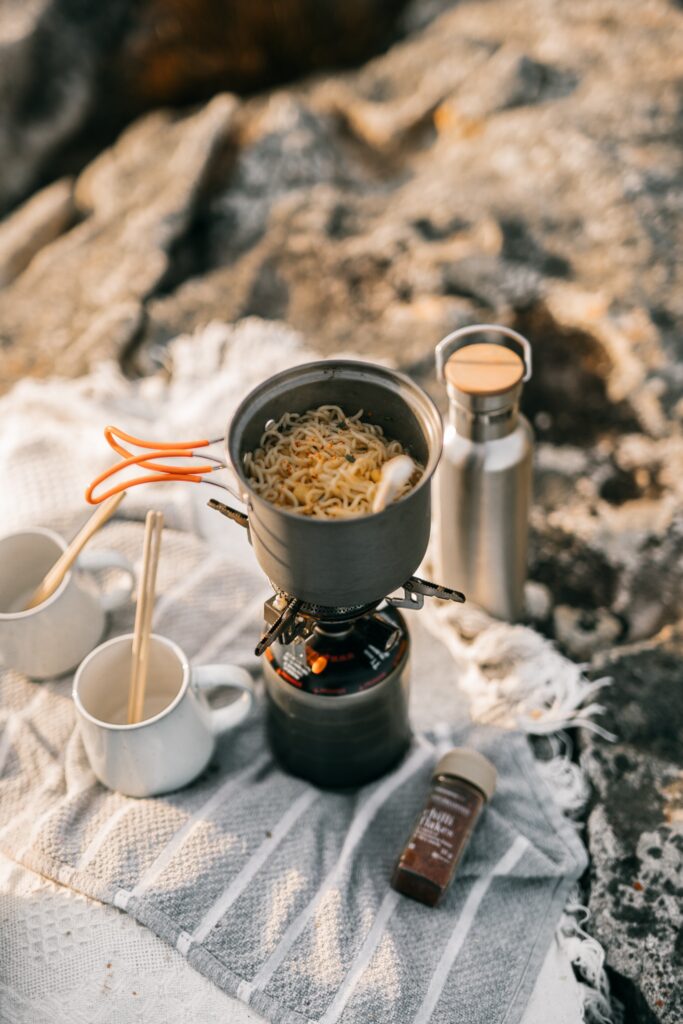 A portable stove cooking noodles image