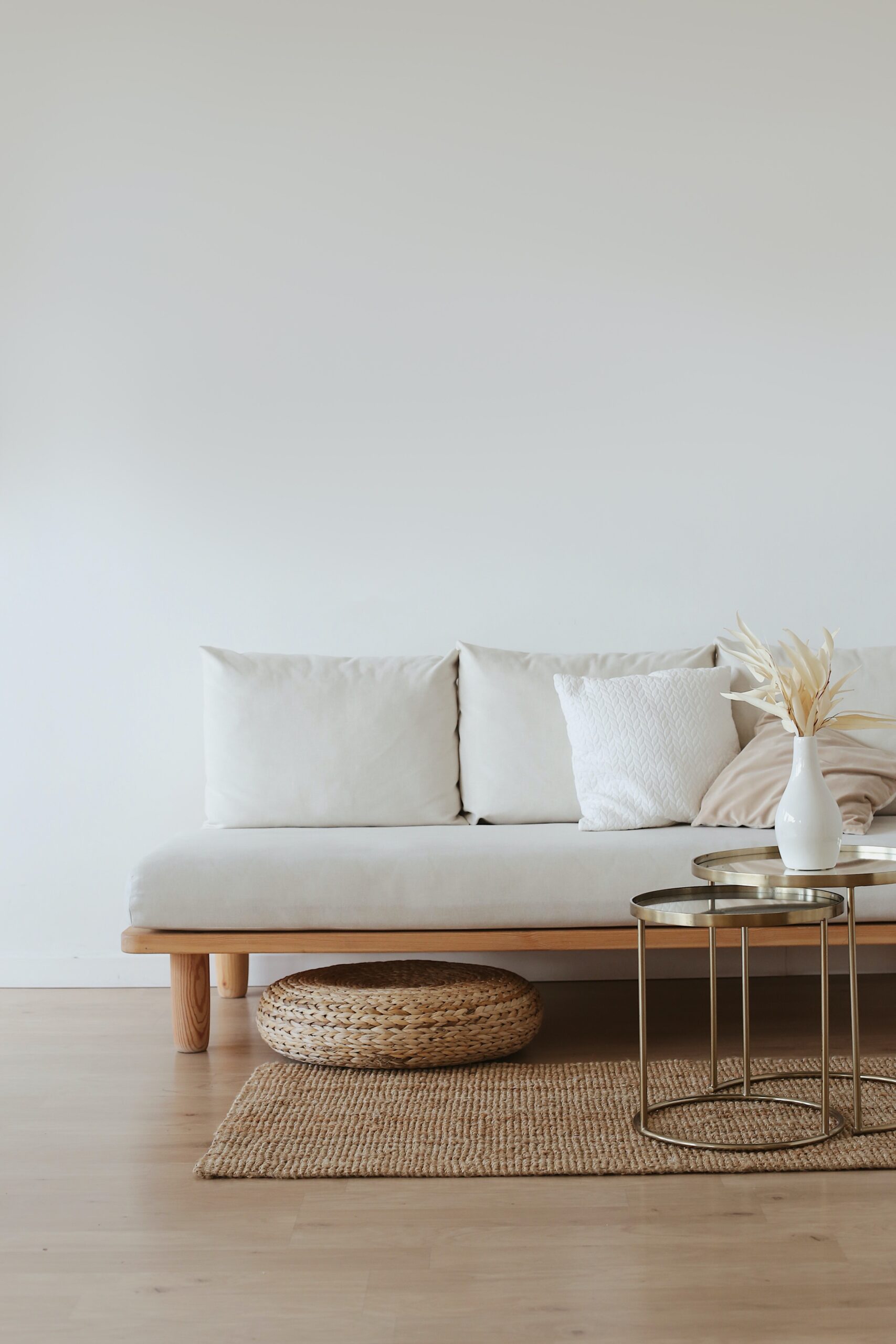 A wooden couch with white cushions image