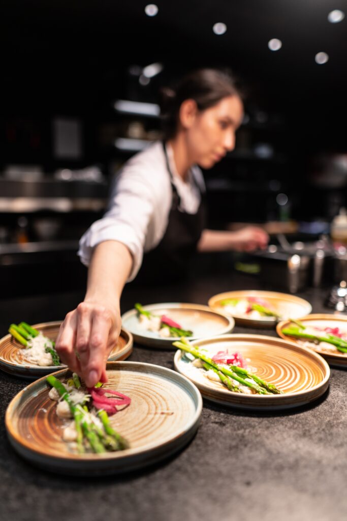 a chef preparing food on plates image